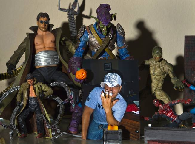 Photo of Cesar Flores about some of his action figures on Friday, August 8, 2014.