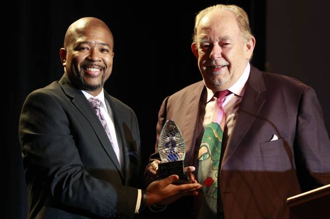 88.1 KCEP-FM General Manager Craig Knight stand with Robin Leach and his NBA Ambassador Award during the 19th annual Nevada Broadcasters Hall of Fame gala Saturday, Aug. 9, 2014, at the Four Seasons Las Vegas.