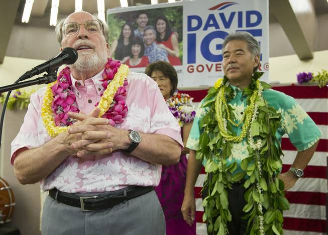 Hawaii Governor Neil Abercrombie, left, addresses the supporters of Hawaii State Sen. David Ige as Ige, right, looks on Saturday, Aug. 9, 2014, in Honolulu. Ige defeated Abercrombie in the state's primary election to win the Democratic Party's nomination. Abercrombie, who has spent nearly 40 years in Hawaii politics, is the first Hawaii governor to lose to a primary challenger and only the second not to win re-election.