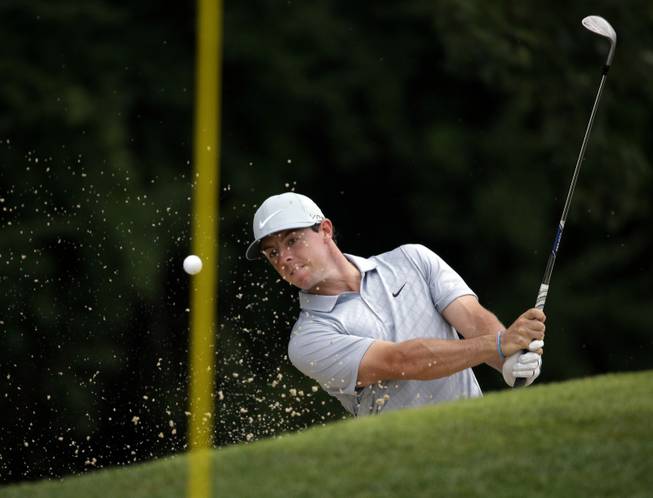 Rory McIlroy hits out of the bunker on the third hole during the second round of the PGA Championship golf tournament at Valhalla Golf Club on Friday, Aug. 8, 2014, in Louisville, Ky.