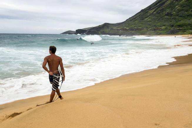 Honolulu resident Tim Rowland, looks over the waves at Sandy Beach Park, Friday, Aug. 8, 2014, in Honolulu. 
