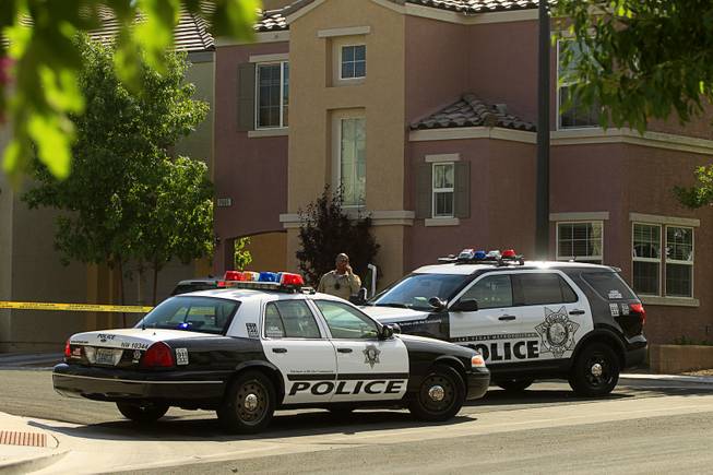 Metro Police vehicles block access to Calico Fields Street after an officer-involved shooting near Fort Apache and Farm roads Monday, Aug. 11, 2014. A suspect was shot after officers responded to a disturbance call.