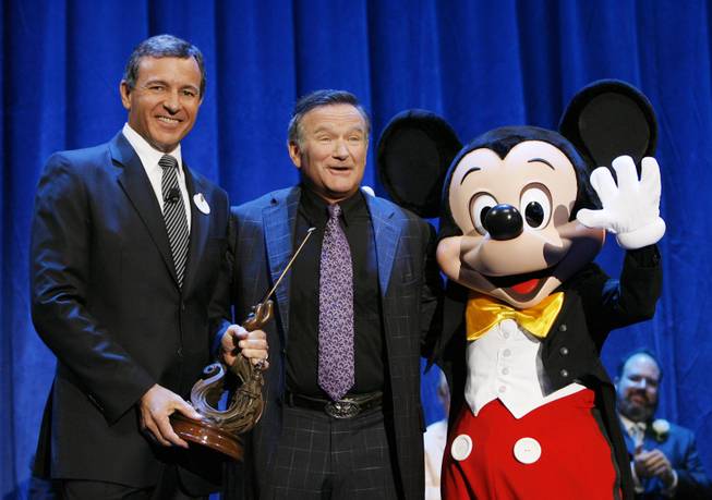 Robert Iger, president and CEO of The Walt Disney Co., Robin Williams and Mickey Mouse at Disneyland on Sept. 10, 2009, in Anaheim. Calif.


