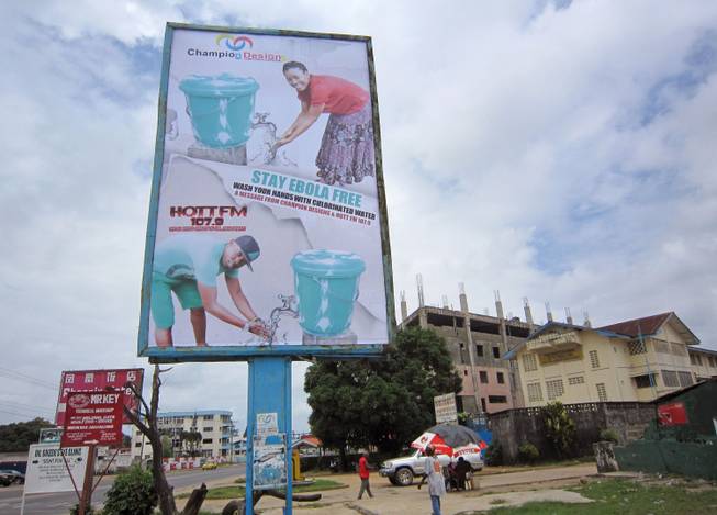 In this image taken Saturday, Aug. 9, 2014, a large billboard promoting the washing of hands to prevent the spread of the deadly Ebola virus in Monrovia, Liberia.