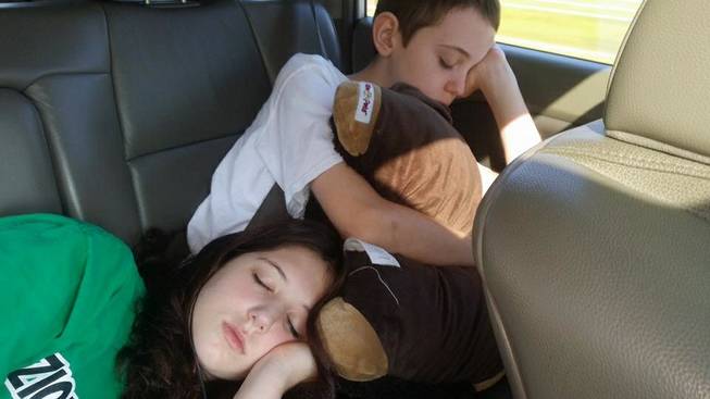 Kevin Burke’s children McKenna and Griffin asleep in the minivan.