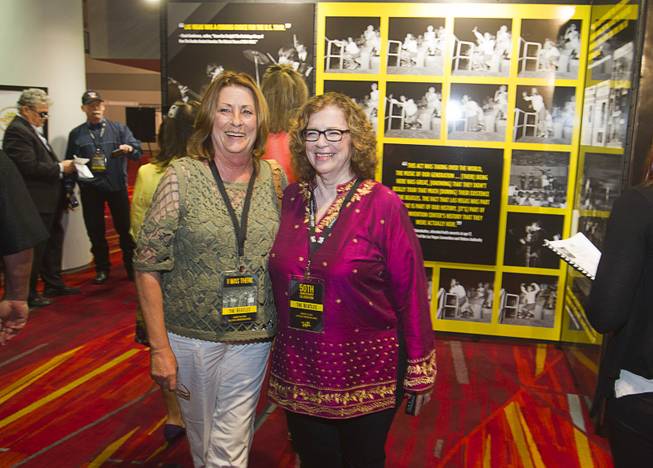 Ramona Hobart, left, and Amy Ayoub pose before a news conference in the lobby of the Las Vegas Convention Center Tuesday, Aug. 12, 2014. The pair attended the Beatles concert in Las Vegas on August 20, 1964. A multi-media exhibition commemorating the concert will be on display in the lobby of the LVCC through Oct. 27.