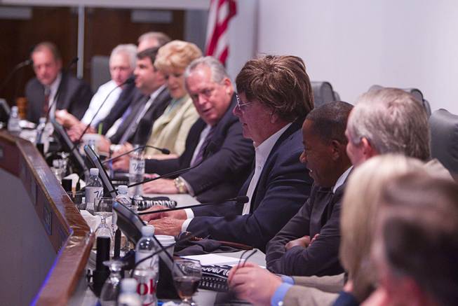Clark County Commissioner Tom Collins, center, wears a Beatles wig and glasses during a Las Vegas Convention and Visitors Authority (LVCVA) board meeting at the Las Vegas Convention Center Tuesday, Aug. 12, 2014. A news conference that followed in the lobby of the convention center celebrated the 50th anniversary of the Beatles concert in Las Vegas on August 20, 1964. A multi-media exhibition commemorating the event will be on display in the lobby of the LVCC through Oct. 27.