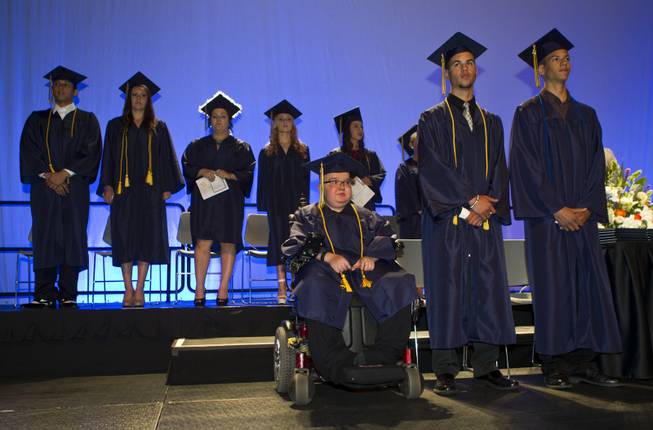 Lifelong friends Colton Shrum, D'Aron Martin and Darius Martin stand with other students at the Cashman Center  for their Odyssey Charter School graduation on Tuesday, June, 3, 2014.  L.E. Baskow
