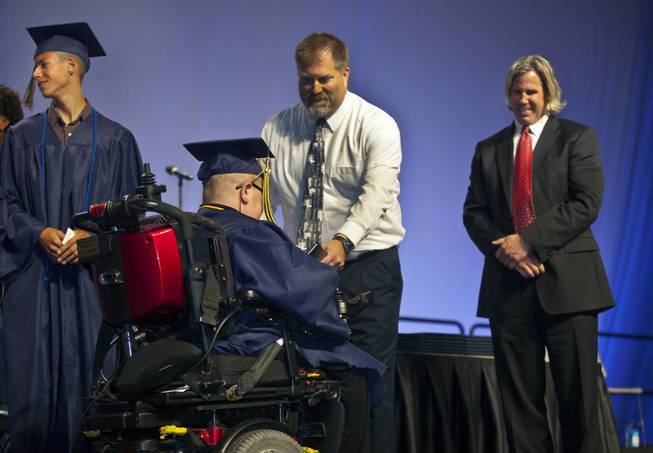Colton Shrum receives his diploma during the Cashman Center  for their Odyssey Charter School graduation on Tuesday, June, 3, 2014.  L.E. Baskow