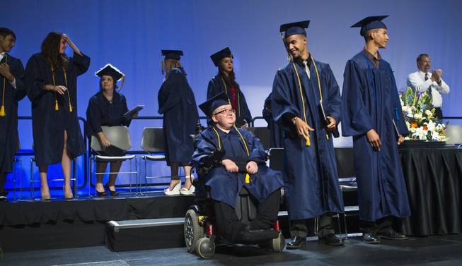 Lifelong friends Darius Martin, Colton Shrum and D'Aron Martin are all smiles during the Odyssey Charter School graduation at the Cashman Center on Tuesday, June, 3, 2014.  L.E. Baskow