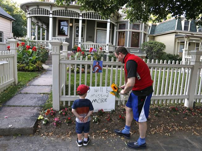 U.S. Rep. Jared Polis, D-Colo., and his son AJ leave flowers at the home where the 80's TV series "Mork & Mindy", starring the late Robin Williams, was set, in Boulder, Colo., Monday Aug. 11, 2014. Robin Williams, the Academy Award winner and comic supernova whose explosions of pop culture riffs and impressions dazzled audiences for decades and made him a gleamy-eyed laureate for the Information Age, died Monday in an apparent suicide. He was 63. 