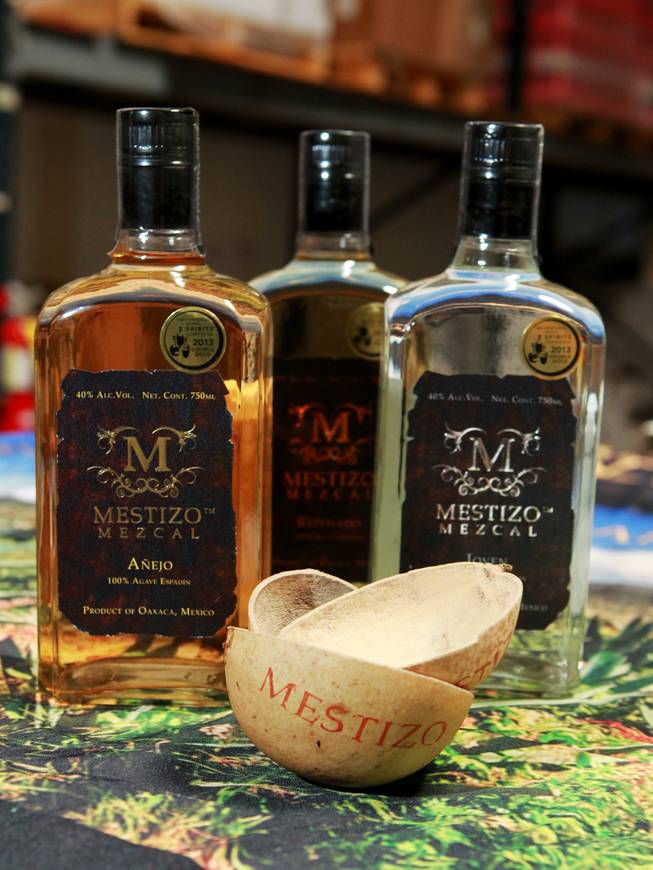 Three different mescals from Skere Spirits are seen with jicaras, a traditional vessel for drinking mezcal, Friday, Aug. 8, 2014.