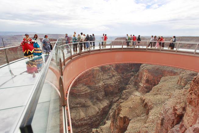 Visitors use the Skywalk at Grand Canyon West Tuesday, Aug. 12, 2014.