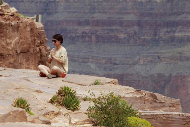 A woman poses for a photo at Grand Canyon West Tuesday, Aug. 12, 2014.