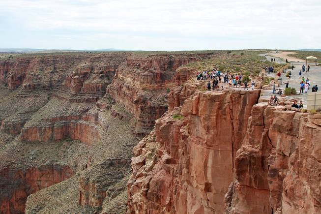 Visitors take in the view of the Grand Canyon at Grand Canyon West Tuesday, Aug. 12, 2014.