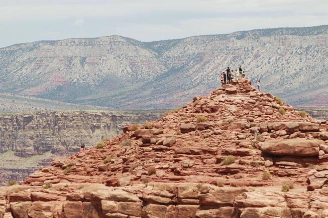 Tourists takes in the view from Guano Point at Grand Canyon West Tuesday, Aug. 12, 2014.