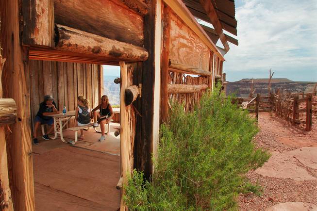 Tourists rest in an abandoned mine building at Guano Point at Grand Canyon West Tuesday, Aug. 12, 2014.