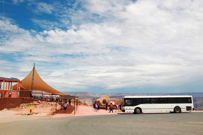 A shuttle bus unloads passengers at Guano Point at Grand Canyon West Tuesday, Aug. 12, 2014.