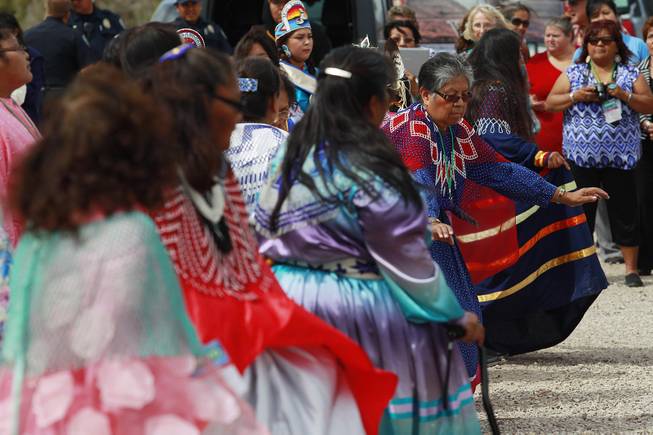 Hualapai Bird Dancers perform a road blessing dance during the official opening of the newly paved section of Diamond Bar Road leading to Grand Canyon West Tuesday, Tuesday, Aug. 12, 2014.