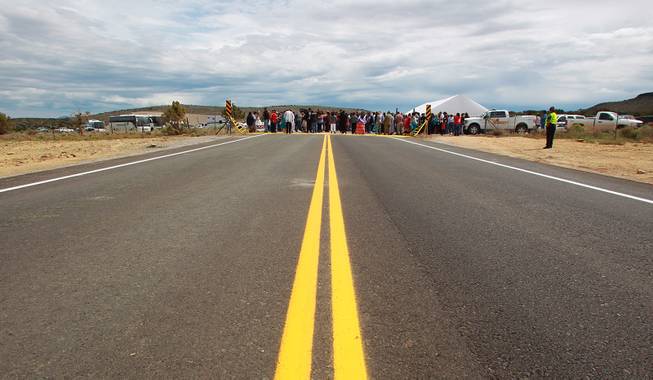 Hualapai tribe members and guests take part in the official opening of the newly paved section of Diamond Bar Road leading to Grand Canyon West Tuesday, Tuesday, Aug. 12, 2014.