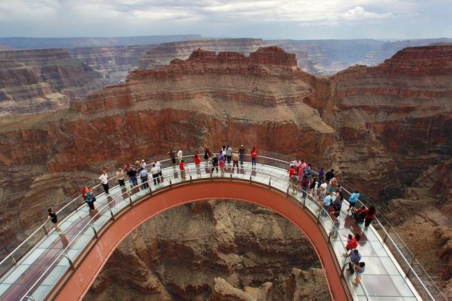 Hualapai tribe members and guests tour the Skywalk after the official opening of the newly paved section of Diamond Bar Road leading to Grand Canyon West Tuesday, Tuesday, Aug. 12, 2014.