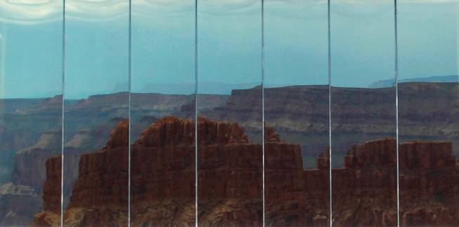 The Grand Canyon is reflected in the windows of Skywalk at Grand Canyon West Tuesday, Tuesday, Aug. 12, 2014.