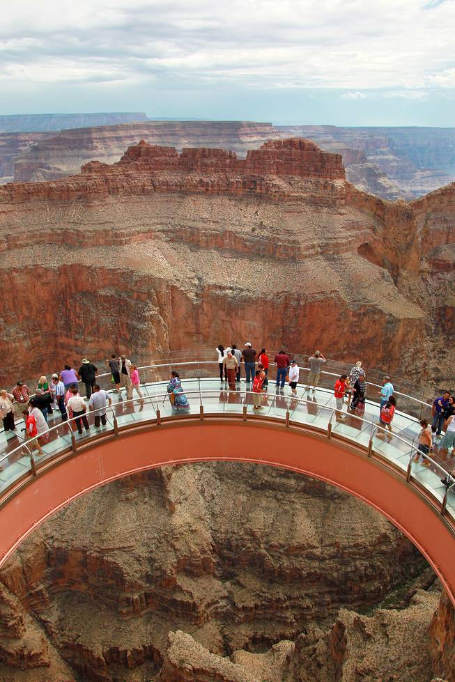 Hualapai tribe members and guests tour the Skywalk after the official opening of the newly paved section of Diamond Bar Road leading to Grand Canyon West Tuesday, Tuesday, Aug. 12, 2014.