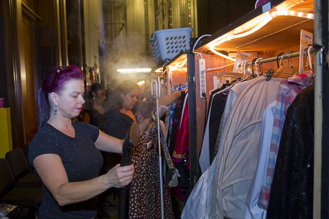Nathaly Big Mountain steams clothes in a wardrobe department during a backstage tour of "Ghost The Musical" at the Smith Center for the Performing Arts Wednesday Aug. 13, 2014. The musical runs through Sunday, Aug. 17.