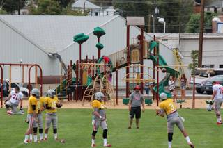 We practice at a public park here in Ely (Broadbent Park) so this is a shot of a quarterback drill in front of the kids using the playground set.