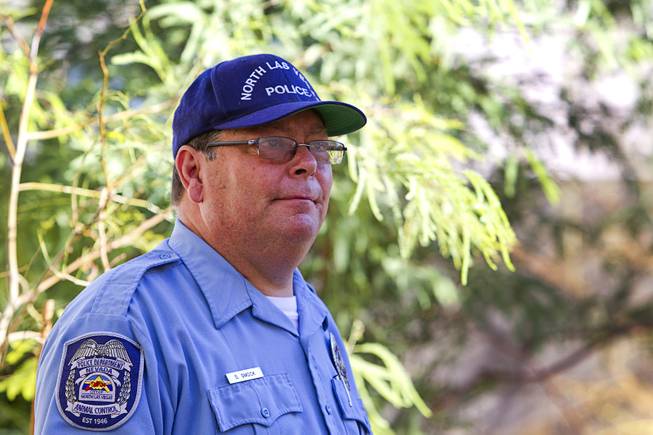 North Las Vegas Animal Control officer Dale Smock is shown in the backyard of a home in North Las Vegas Thursday Aug. 14, 2014. Smock recently helped clear a house of over 100 cats. The house has since been condemned.