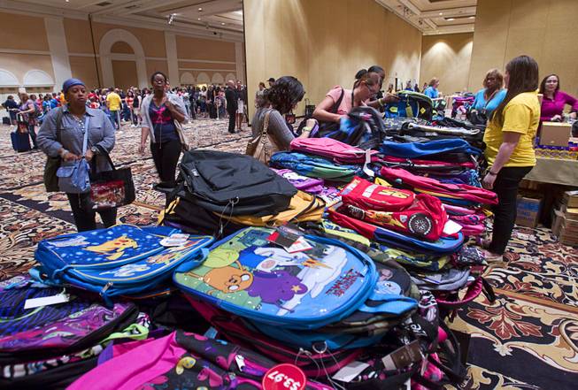 Backpacks are piles on tables during MGM Resorts annual Educator Appreciation Day at the Mirage Thursday Aug. 14, 2014. In addition to school supplies provided by MGM Resort employees, a variety of agencies participated in the days activities to introduce educators to teaching resources available in the community.