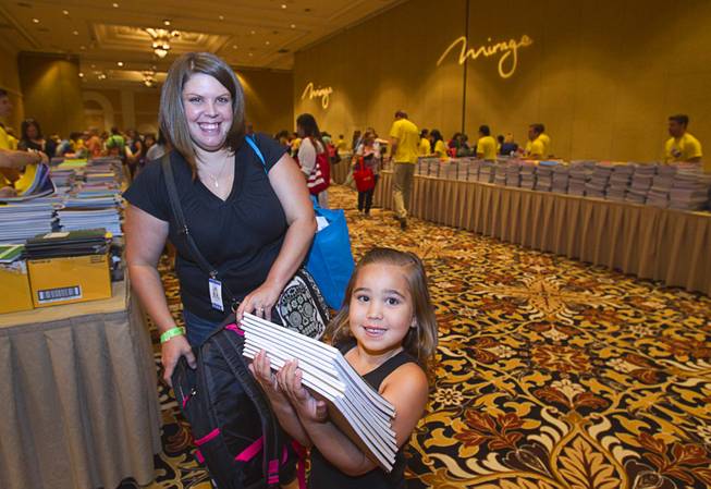 Jovanna Chavez, 6, helps her mother Chrystina Skerstonas with school supplies during MGM Resorts annual Educator Appreciation Day at the Mirage Thursday Aug. 14, 2014. Skerstonas is a special education teacher at Brookman Elementary School. In addition to school supplies provided by MGM Resort employees, a variety of agencies participated in the days activities to introduce educators to teaching resources available in the community.