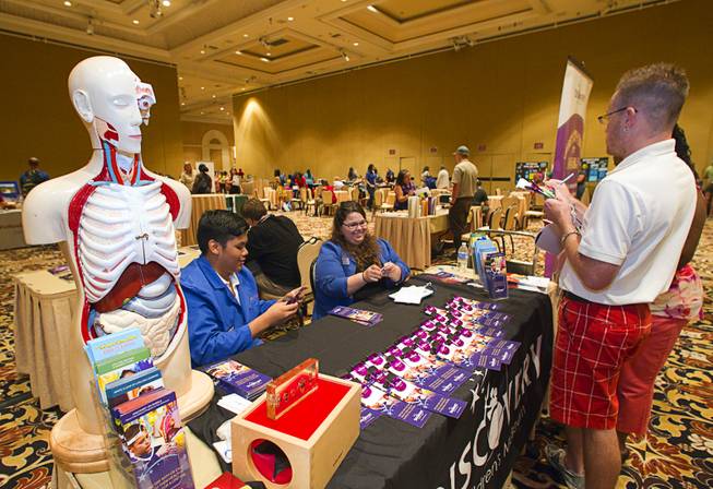 Emmanul Canela and Amanda Svab provide information for teachers at a Children's Discovery Museum table during MGM Resorts annual Educator Appreciation Day at the Mirage Thursday Aug. 14, 2014. In addition to school supplies provided by MGM Resort employees, a variety of agencies participated in the days activities to introduce educators to teaching resources available in the community.