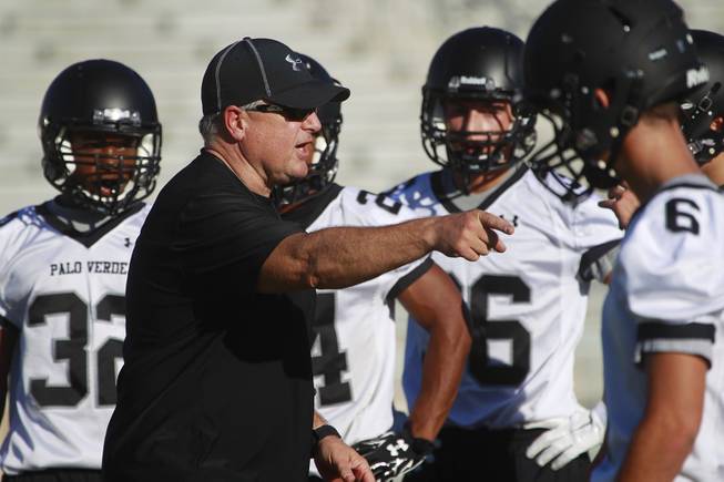 Palo Verde head coach Darwin Rost instructs his players during their first official practice day Thursday, Aug. 14, 2014.