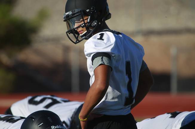 Palo Verde quarterback Graeson Vereen looks over the offensive line during their first official practice Thursday, Aug. 14, 2014.