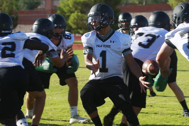 Palo Verde quarterback Graeson Vereen turns while pitching the ball during their first official practice Thursday, Aug. 14, 2014.