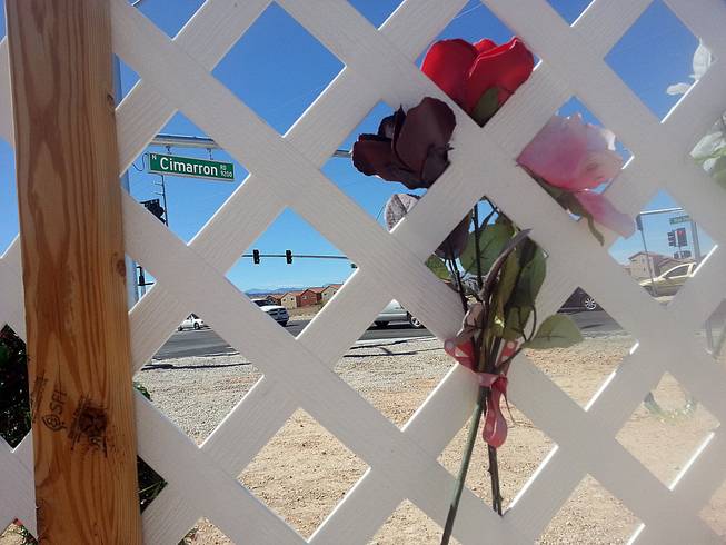 When Helen Liu was killed in November, there was no crosswalk at Blue Diamond and Cimarron roads. Flowers at a memorial are seen at the intersection, which also now features a new crosswalk and traffic light, Thursday, Aug. 14, 2014.
