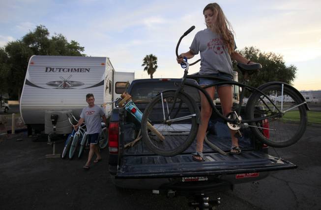 Modesto, Calif., residents Carlos, left, and Isabela Meza unload their bikes as they set up camp for the night at the KOA campground on the Strip. In late September, the camp will lose its lease with Circus Circus, which has other development plans that have sent KOA officials looking for a new site.