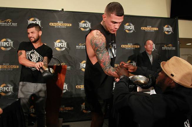 Bryan Vera, left, and Gabriel Rosado try on gloves during a news conference for the inaugural Big Knockout Boxing event Thursday, Aug. 14, 2014.
