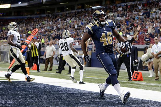 St. Louis Rams tight end Cory Harkey (46) scores a touchdown on a 16-yard pass reception in the first quarter of a preseason NFL football game between the Rams and the New Orleans Saints Friday, Aug. 8, 2014, in St. Louis. 