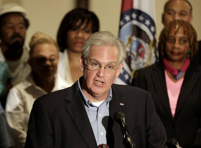 Missouri Gov. Jay Nixon speaks at a news conference dealing with the aftermath of a police shooting of teenager Michael Brown, Saturday, Aug. 16, 2014, in Ferguson, Mo. The governor declared a state of emergency Saturday and imposed a curfew in the St. Louis suburb where police and protesters have clashed after Brown was shot to death by a white police officer a week ago.