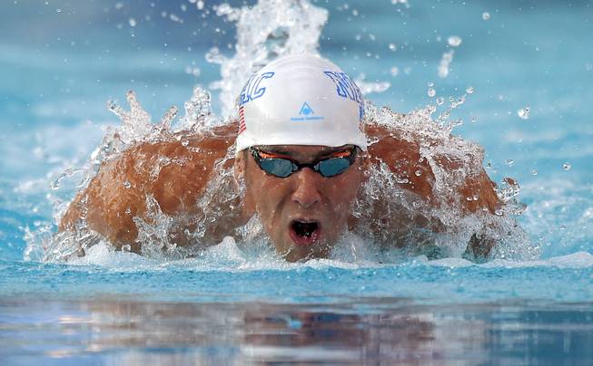 In this Sunday, Aug. 10, 2014, photo, Michael Phelps swims the butterfly in the men's 200-meter individual medley final at the U.S. nationals of swimming in Irvine, Calif.
