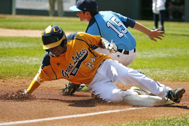 Chicago's Trey Hondras (24) steals third ahead of the tag by Las Vegas third baseman Dillon Jones (15) during the first inning of a baseball game in United States pool play at the Little League World Series tournament in South Williamsport, Pa., Sunday, Aug. 17, 2014. 
