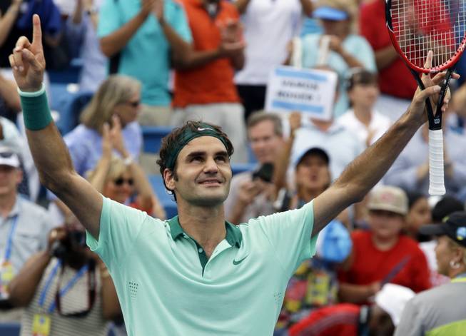 Roger Federer celebrates after defeating David Ferrer 6-3, 1-6, 6-2 in a final match at the Western and Southern Open tennis tournament Sunday, Aug. 17, 2014, in Mason, Ohio. 