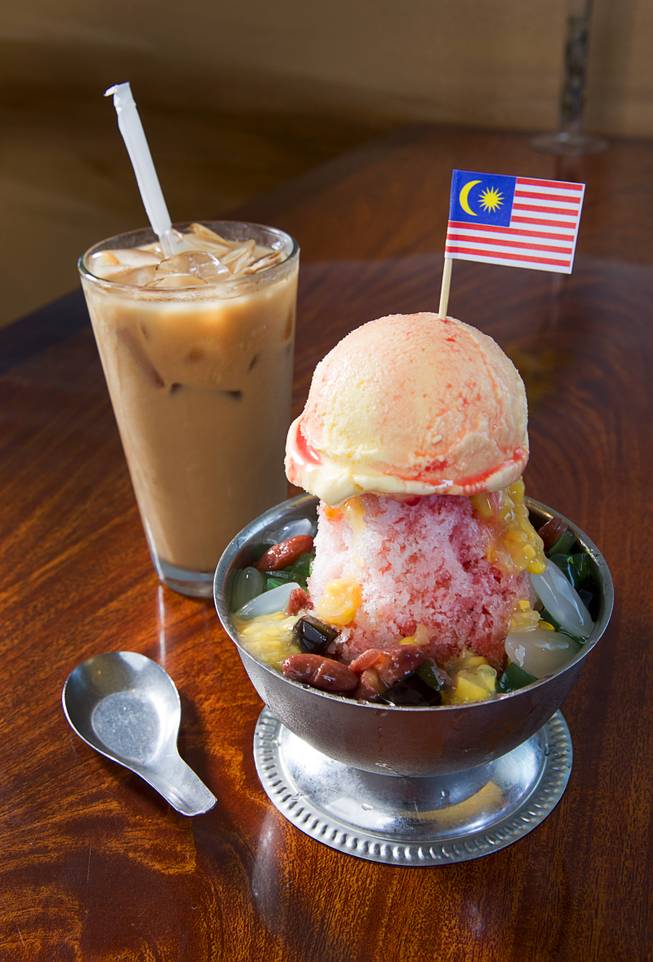 Ice Kacang with Ice Cream (Ice cream over shaved ice with red bean, corn, palm seeds, jelly, red rose syrup and evaporated milk - $5.50) at Island Malaysian Cuisine in the Pacific Asian Plaza, 5115 Spring Mountain Rd., Tuesday, Aug. 19, 2014. Pictured with sweet Malaysian iced tea.