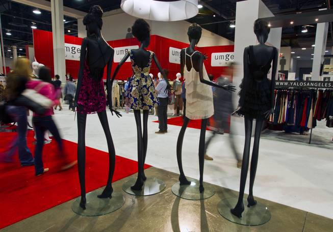 New dresses with Ark & Co. adorn extra tall and thin mannequins during the MAGIC Marketplace Fall Show at the Las Vegas Convention Center on Tuesday, August 19, 2014.