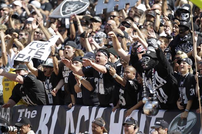 Oakland Raiders fans in the Black Hole cheer during the first quarter of their NFL football game against the New England Patriots in Oakland, Calif., Sunday, Oct. 2, 2011.