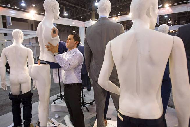 A vendor, who preferred not to be identified, breaks down a display at the Peerless Clothing booth at the conclusion of the Modern Assembly fashion trade show at the Sands Expo & Convention Center Wednesday, Aug. 20, 2014. The show is a collection of six shows: The Accessories Show, Agenda, Capsule, Liberty, Mrket, and Stitch.