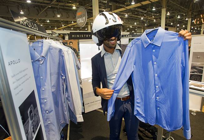 Gihan Amarasiriwardena models a flight helmet as he shows off the Apollo line of shirts at the Ministry of Industry booth during the Modern Assembly fashion trade show at the Sands Expo & Convention Center Wednesday, Aug. 20, 2014. The shirts incorporate NASAs Phase Change Materials to help regulate temperature, absorbing heat away from your skin when you are overheated and releasing it back when you need it. The show is a collection of six shows: The Accessories Show, Agenda, Capsule, Liberty, Mrket, and Stitch.