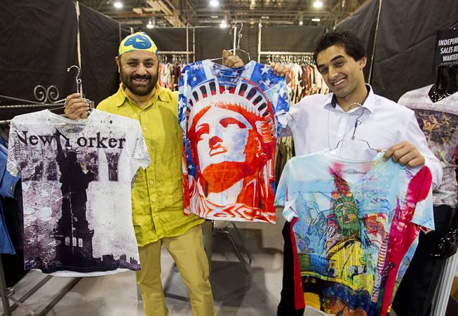 Designer Roger Kohli and his son Zack, of New York City, display some of their digital print T-shirts at the One In A Million booth during the Modern Assembly fashion trade show at the Sands Expo & Convention Center Wednesday, Aug. 20, 2014. The company started with 10 designs but the shirts have been so successful that they now have 110 styles, Roger Kohli said. The show is a collection of six shows: The Accessories Show, Agenda, Capsule, Liberty, Mrket, and Stitch.